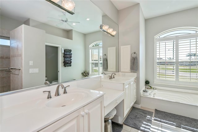 bathroom with ceiling fan, toilet, tile patterned floors, a bathtub, and vanity