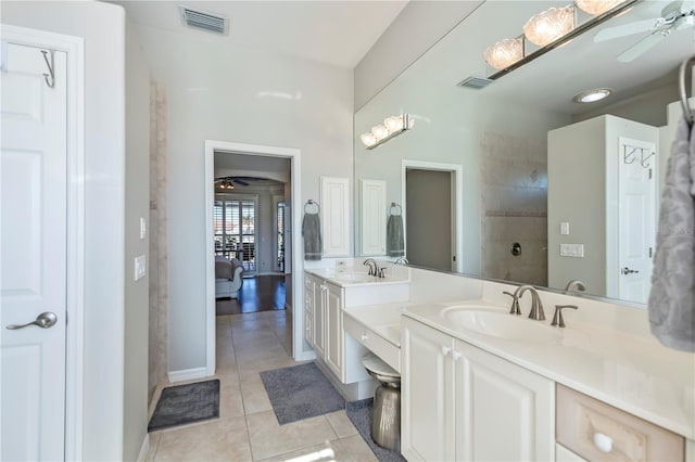 bathroom featuring ceiling fan, tile patterned flooring, a shower, and vanity