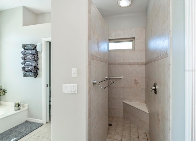 bathroom with a tile shower and tile patterned floors