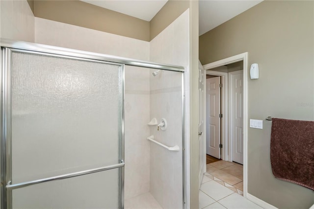 bathroom with walk in shower and tile patterned flooring