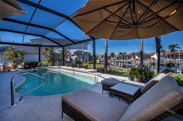 view of pool featuring a patio area and glass enclosure