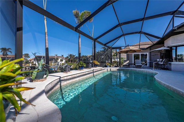 view of swimming pool with a lanai and a patio area