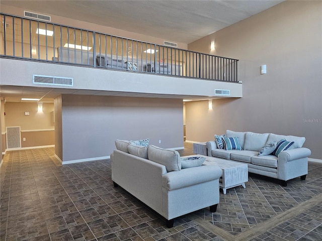 living room featuring a towering ceiling