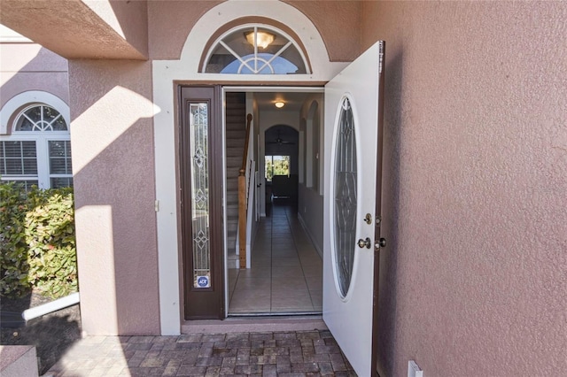 view of exterior entry with stucco siding