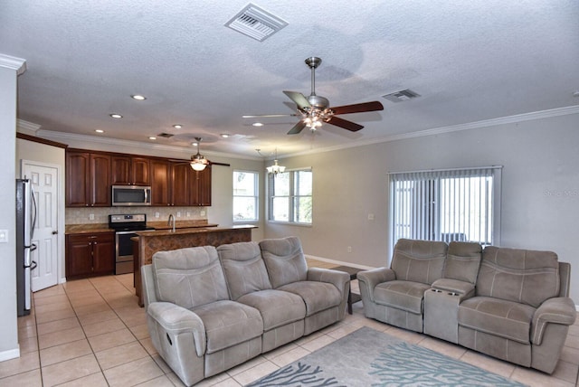 living room featuring light tile patterned flooring, visible vents, and ornamental molding