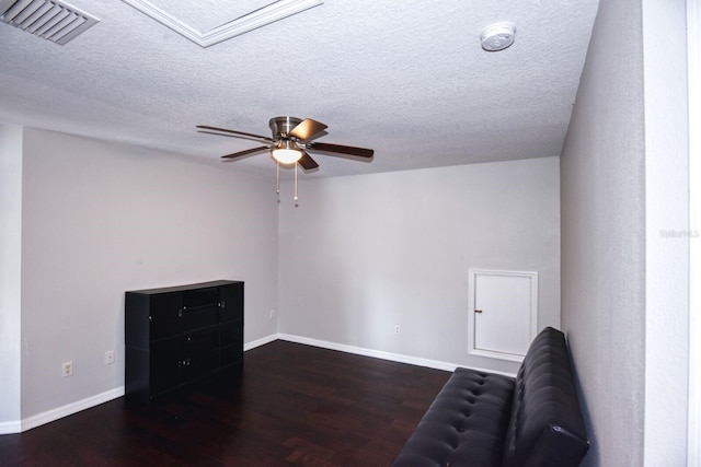 unfurnished room featuring visible vents, baseboards, wood finished floors, a textured ceiling, and a ceiling fan