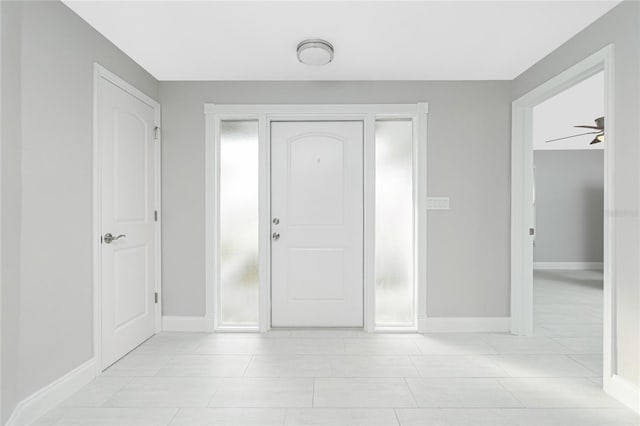 entrance foyer featuring light tile patterned flooring and ceiling fan