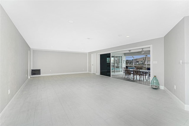 unfurnished living room featuring ceiling fan