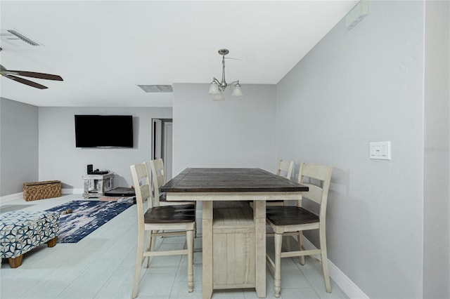 dining space with ceiling fan with notable chandelier