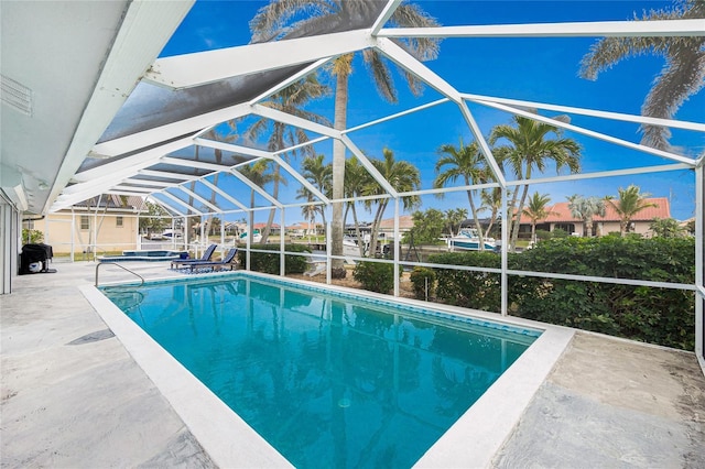 view of swimming pool with a patio and glass enclosure