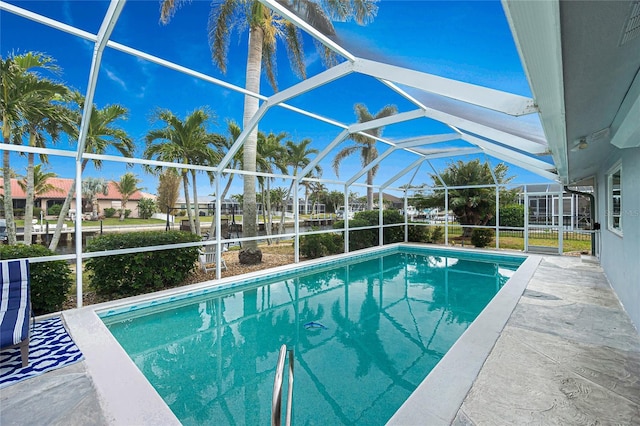 view of pool featuring a patio area and glass enclosure