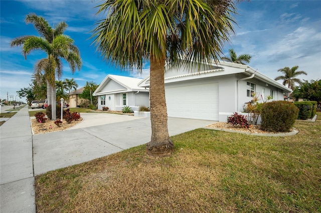 view of front of property featuring a garage and a front yard