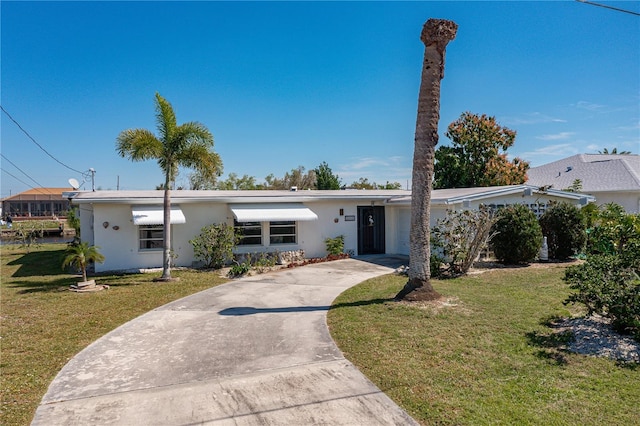 ranch-style home featuring a front yard