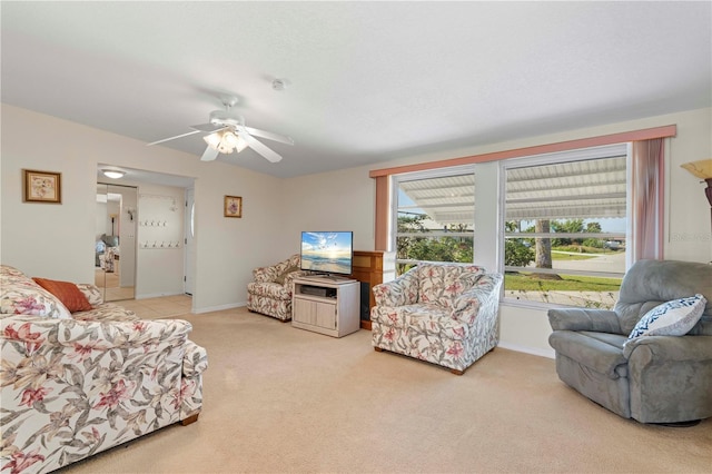 living room with ceiling fan and carpet floors