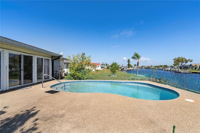 view of swimming pool with a patio area and a water view