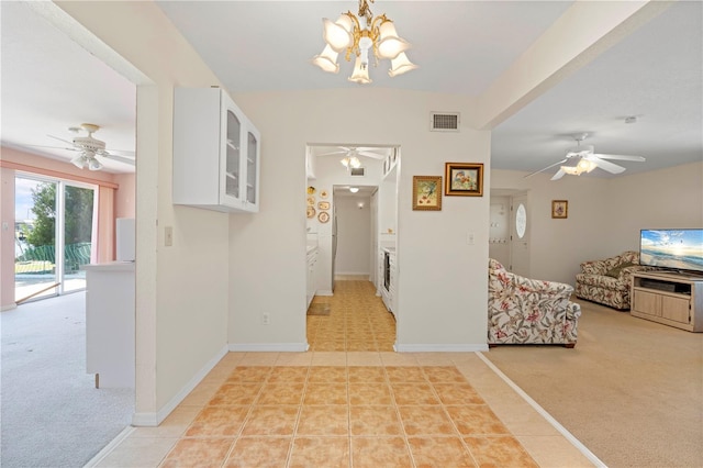 corridor with a notable chandelier and light tile patterned flooring