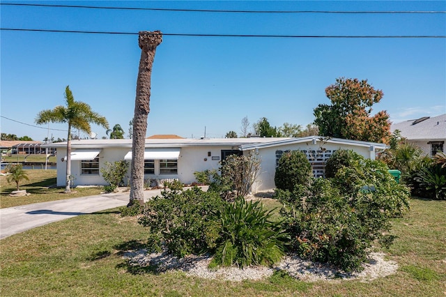 ranch-style home featuring a front yard