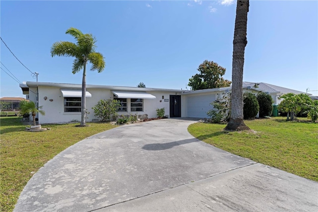 single story home with a garage and a front lawn