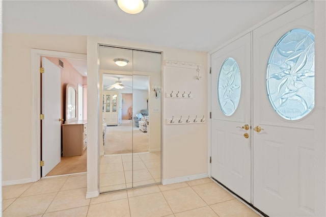 tiled foyer entrance featuring ceiling fan