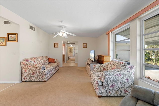 carpeted living room with ceiling fan