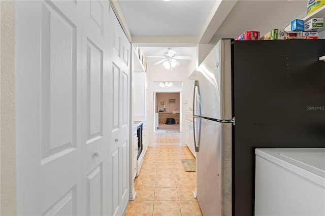 kitchen with stainless steel refrigerator, ceiling fan, and light tile patterned floors