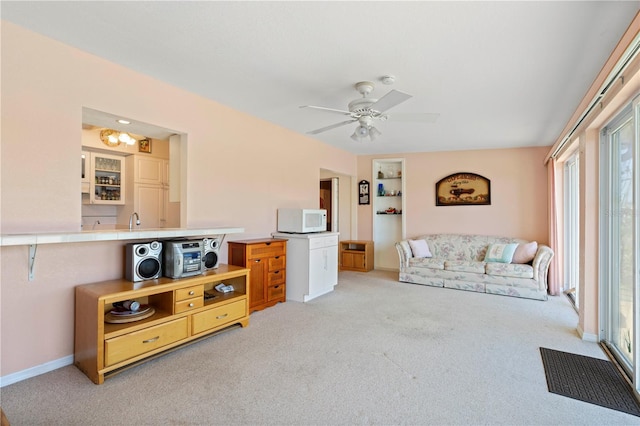 living room with ceiling fan and light carpet