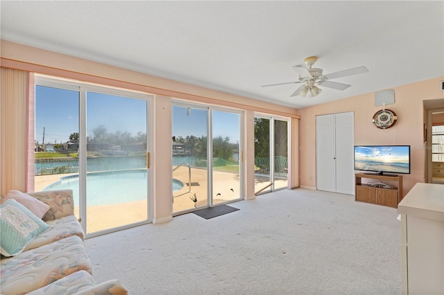 carpeted living room with ceiling fan