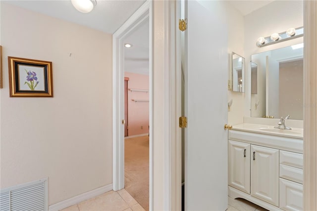 bathroom featuring tile patterned flooring and vanity