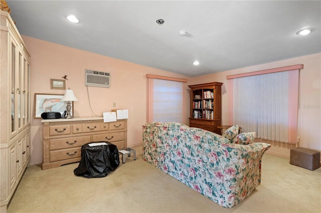 living area with a wall mounted air conditioner, light carpet, and vaulted ceiling