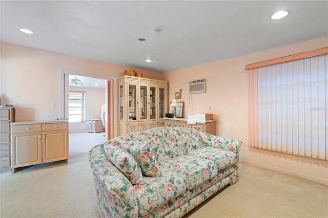 living room with light colored carpet and an AC wall unit