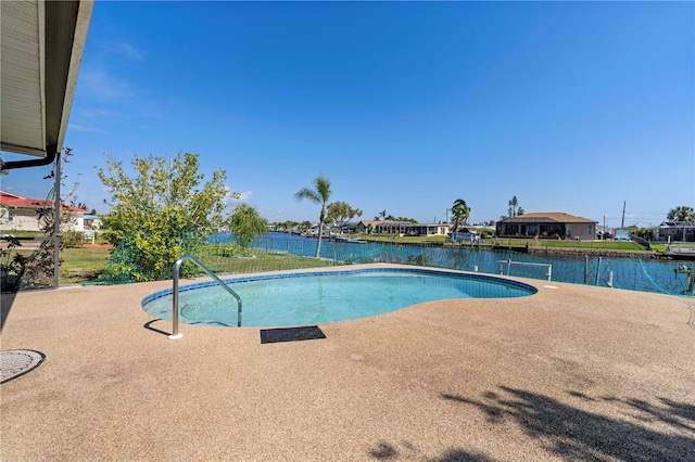 view of swimming pool with a patio area and a water view