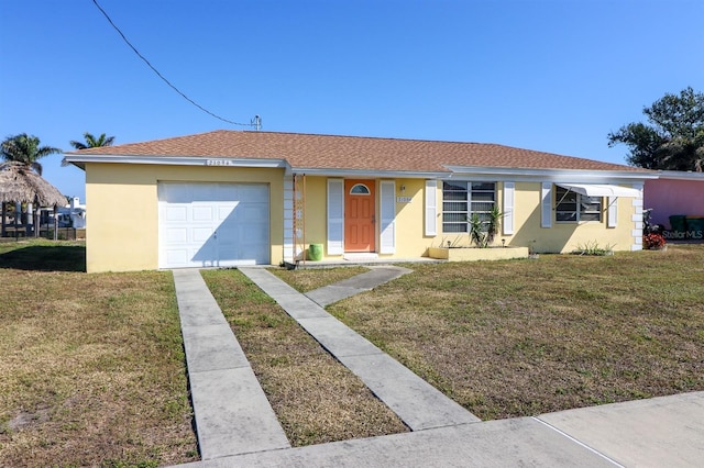 single story home featuring a front yard and a garage