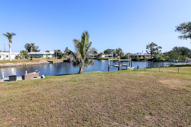 exterior space featuring a lawn and a water view