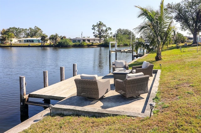 dock area with an outdoor living space with a fire pit, a yard, and a water view