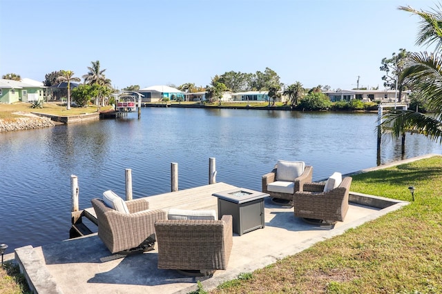 view of dock with an outdoor fire pit and a water view