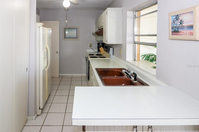 kitchen featuring white appliances, light tile patterned floors, white cabinets, ceiling fan, and sink