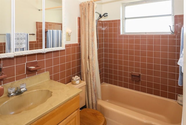 full bathroom with tile walls, toilet, shower / tub combo, and vanity