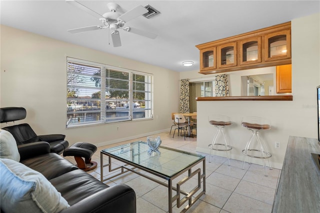 tiled living room featuring ceiling fan