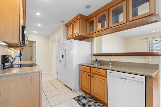 kitchen with sink, light tile patterned floors, and white appliances