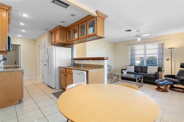 kitchen with ceiling fan, white appliances, sink, and light tile patterned floors