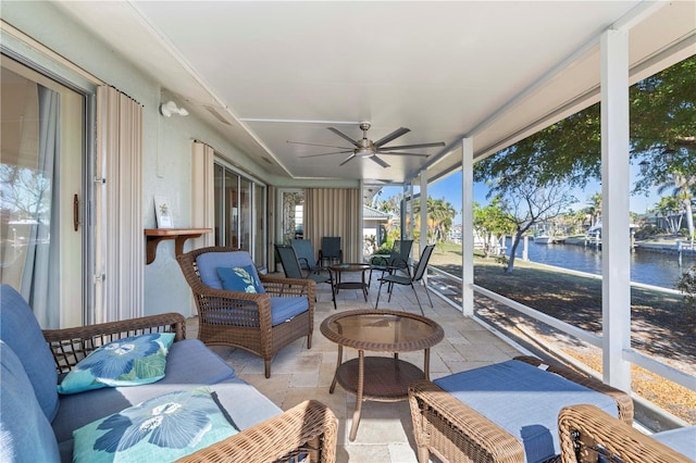 sunroom / solarium featuring a water view