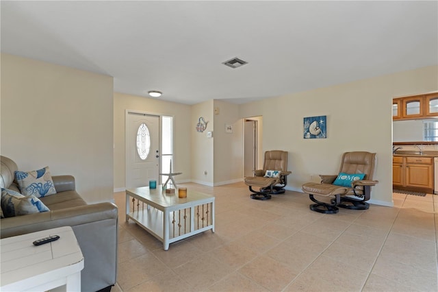 tiled living room featuring sink