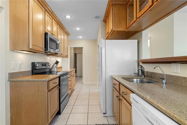 kitchen with light stone countertops, white appliances, sink, and light tile patterned floors