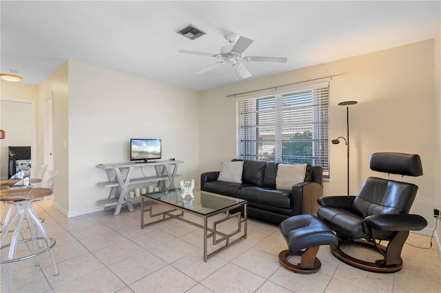 living room featuring ceiling fan and light tile patterned floors