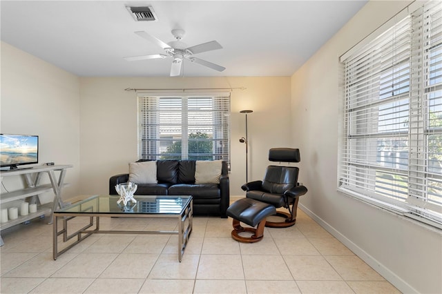 living room featuring light tile patterned floors and ceiling fan