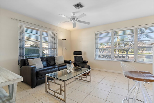 living room featuring ceiling fan, plenty of natural light, and light tile patterned floors