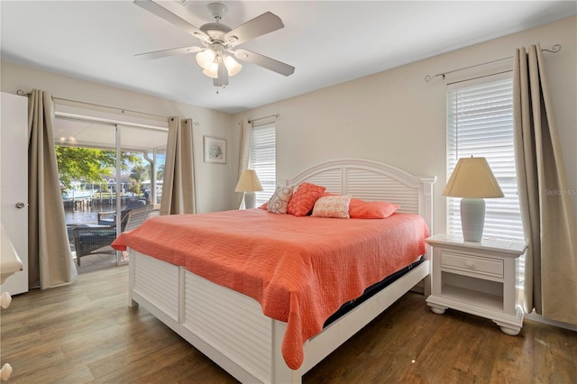 bedroom featuring dark hardwood / wood-style flooring, access to outside, and ceiling fan