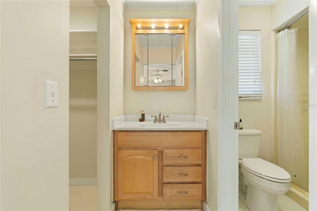 bathroom featuring tile patterned floors, ceiling fan, vanity, and toilet