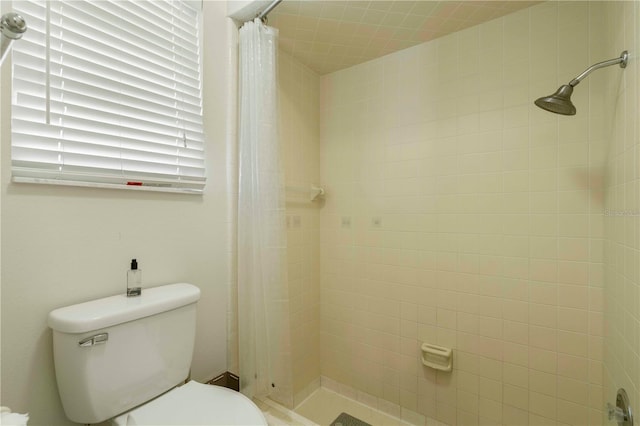 bathroom featuring toilet and walk in shower