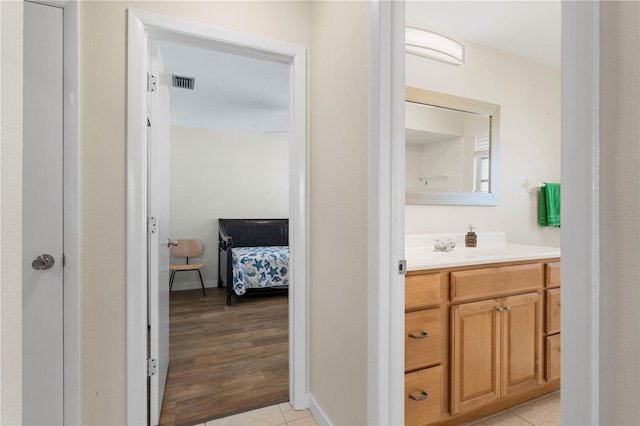 bathroom with tile patterned flooring and vanity